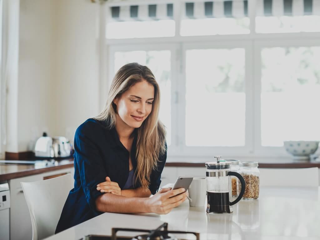 Woman with phone and coffee